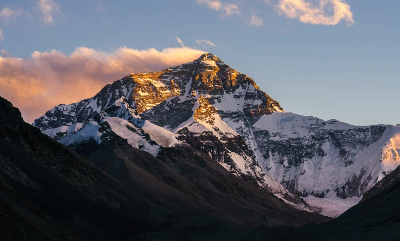 mountains and valleys under a cloudy blue sky