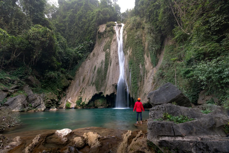 a person standing in front of a waterfall