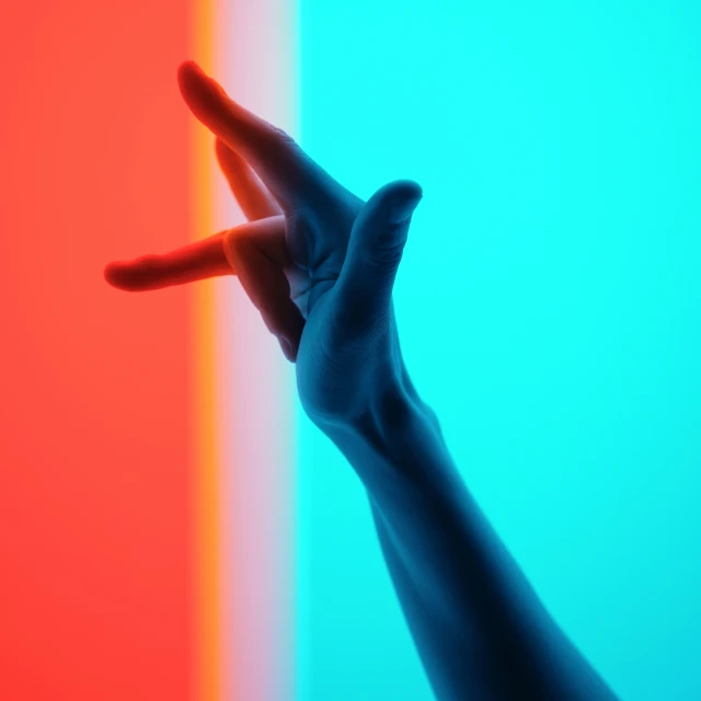 a person with one hand in front of a multicolored background