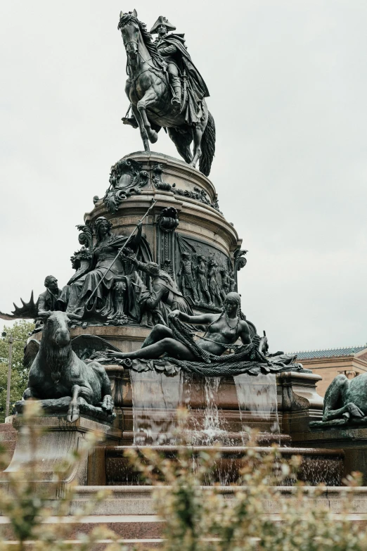 a statue of a horse with people all around it