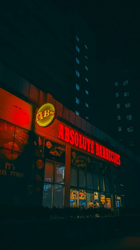 a lighted sign on a restaurant at night