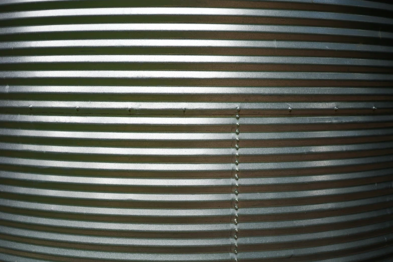 closeup of a metal container with many vertical lines of varying color