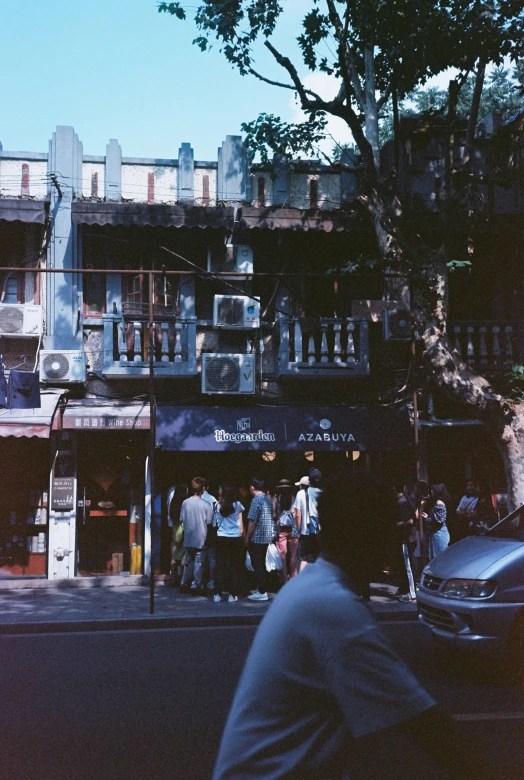 a large group of people standing near a building