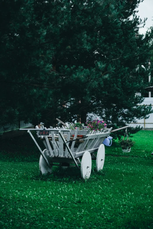 a wagon with wheels and plants in the background