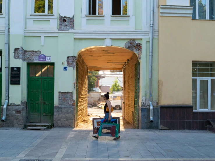 a man is moving a suitcase in an alley