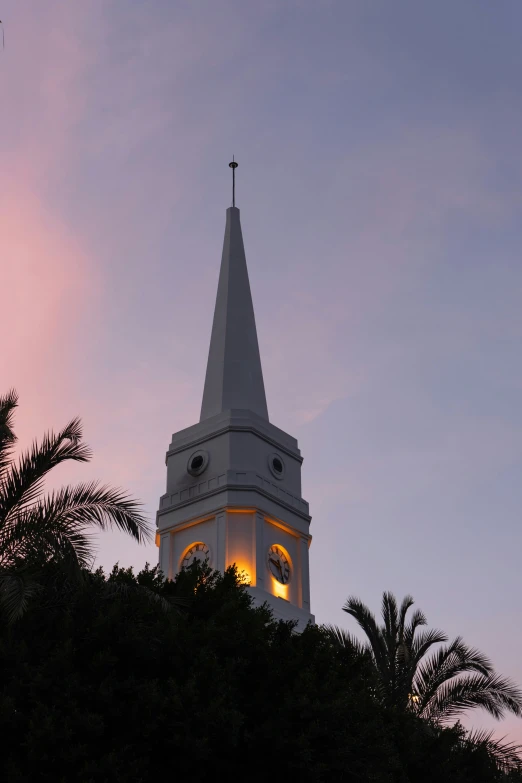 a large white steeple with a light on it