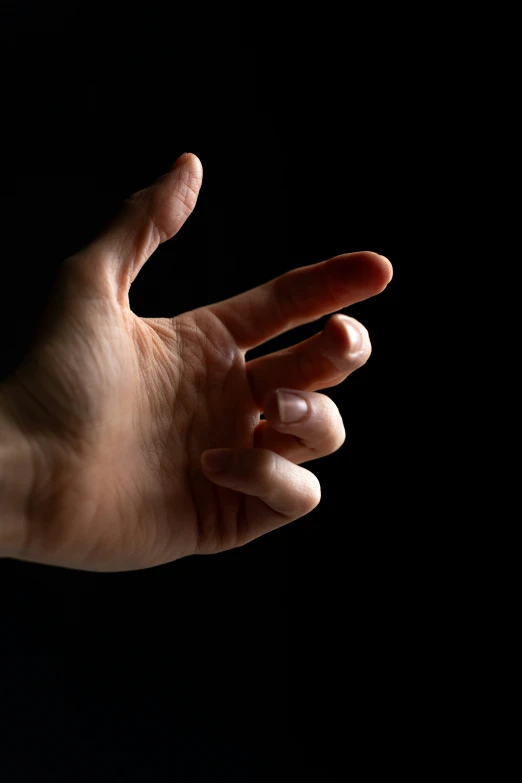 person is using a small plastic hand as the palm of their fingers