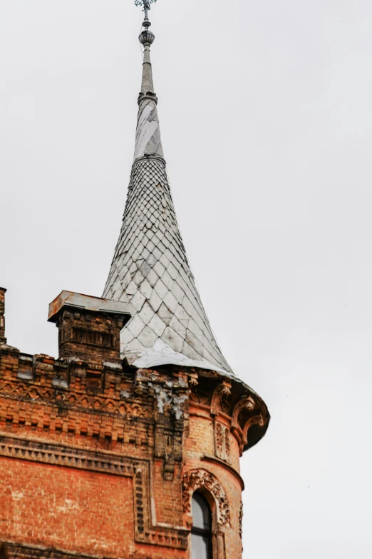 the top of an old brick building with a steeple