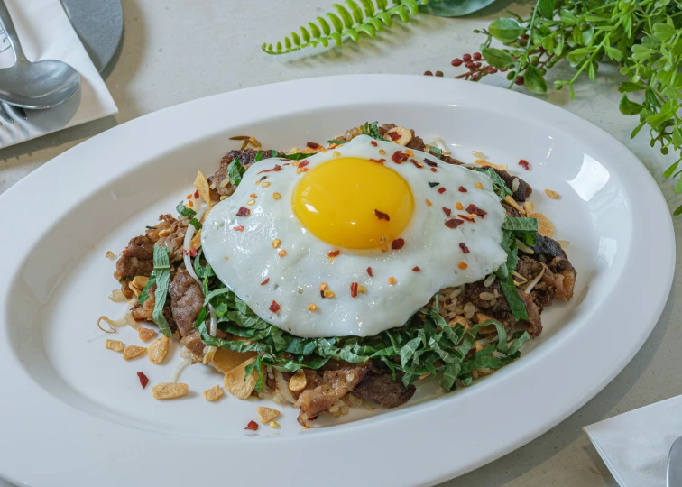 a plate with some food on it and a fried egg