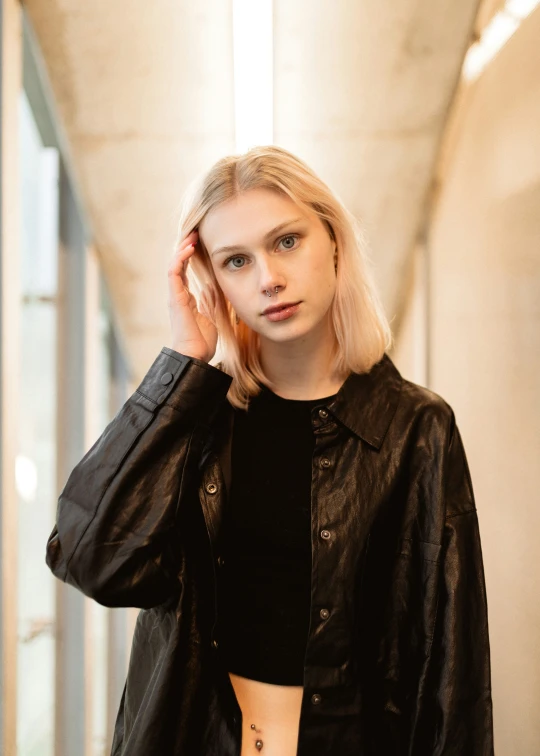 a woman with long blonde hair wearing black shirt