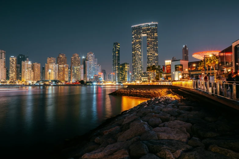 the city skyline of abura and red and yellow lights at night