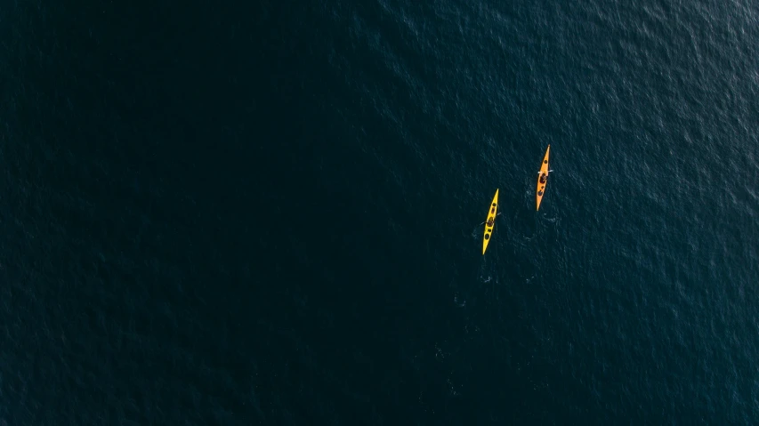 two people in a kayak on an ocean