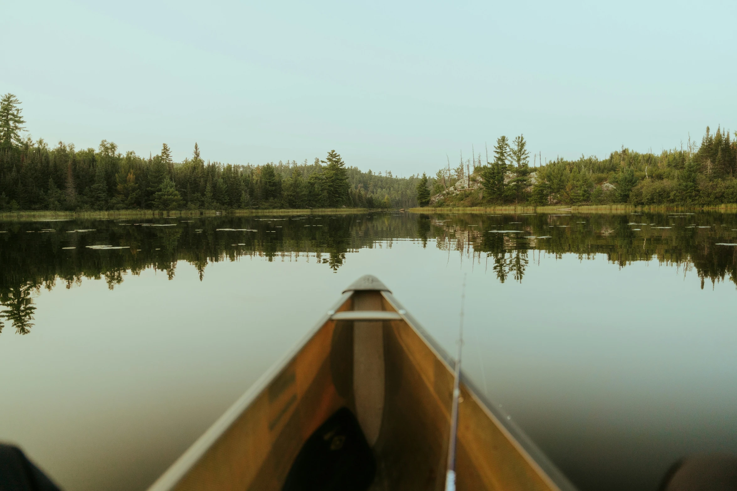 a canoe going through some small water in a lake