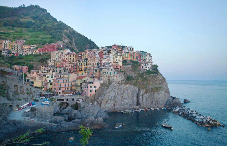 a city perched on top of a hill next to the ocean