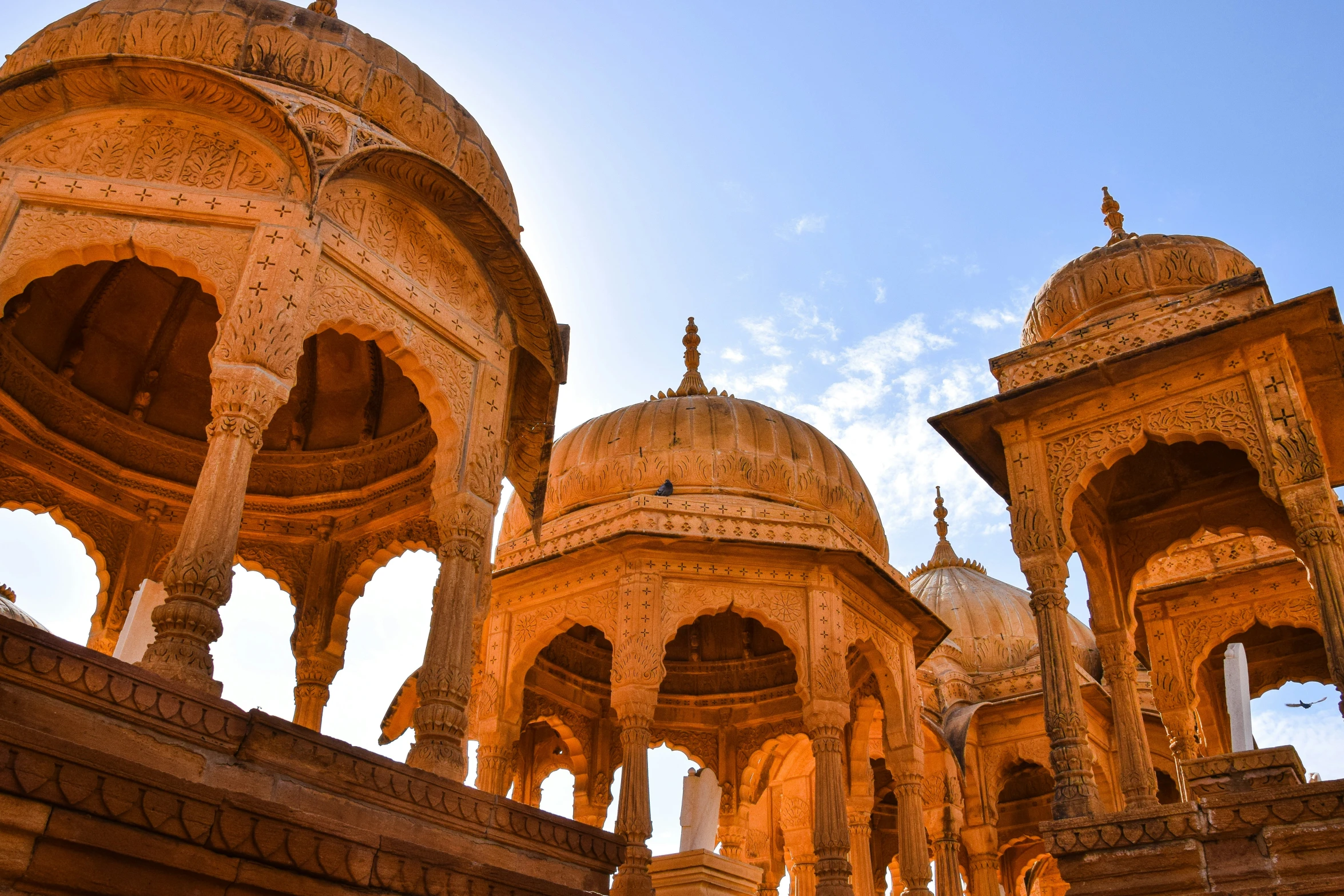 an old and ornate building sitting under a blue sky