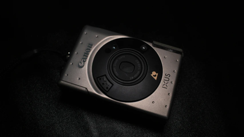 a camera on black surface in a dark room