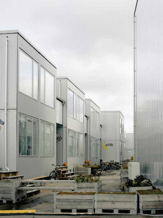 a group of white buildings with a metal structure