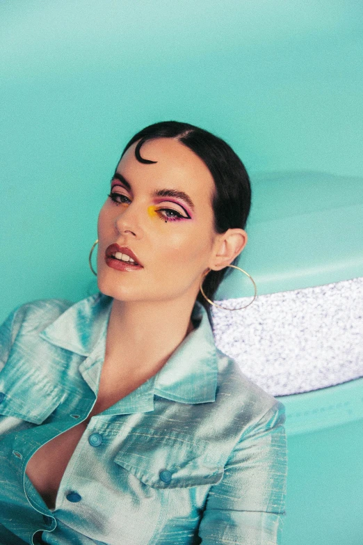 a young woman sitting in a pool wearing blue eyeshades