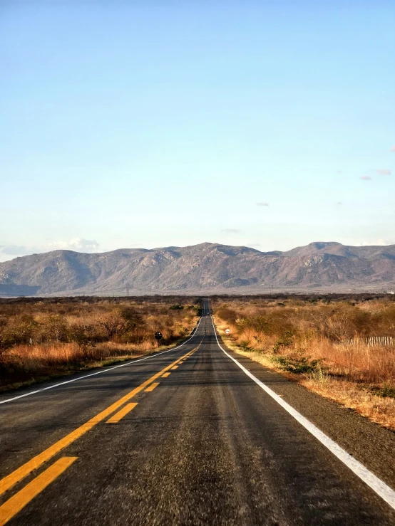 a paved road in the middle of a desert area