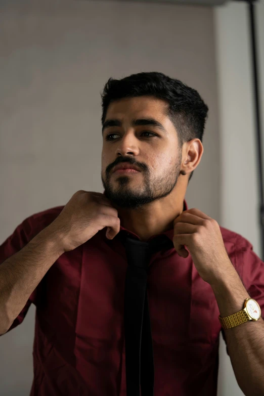 a man adjusting his tie for a wedding ceremony