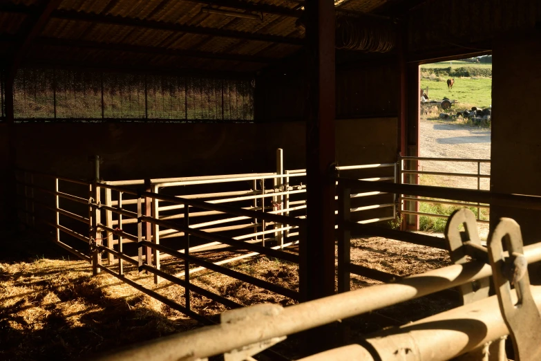 a hay filled barn with a metal gate and window