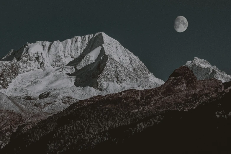 night sky view with white moon and silhouette of mountains