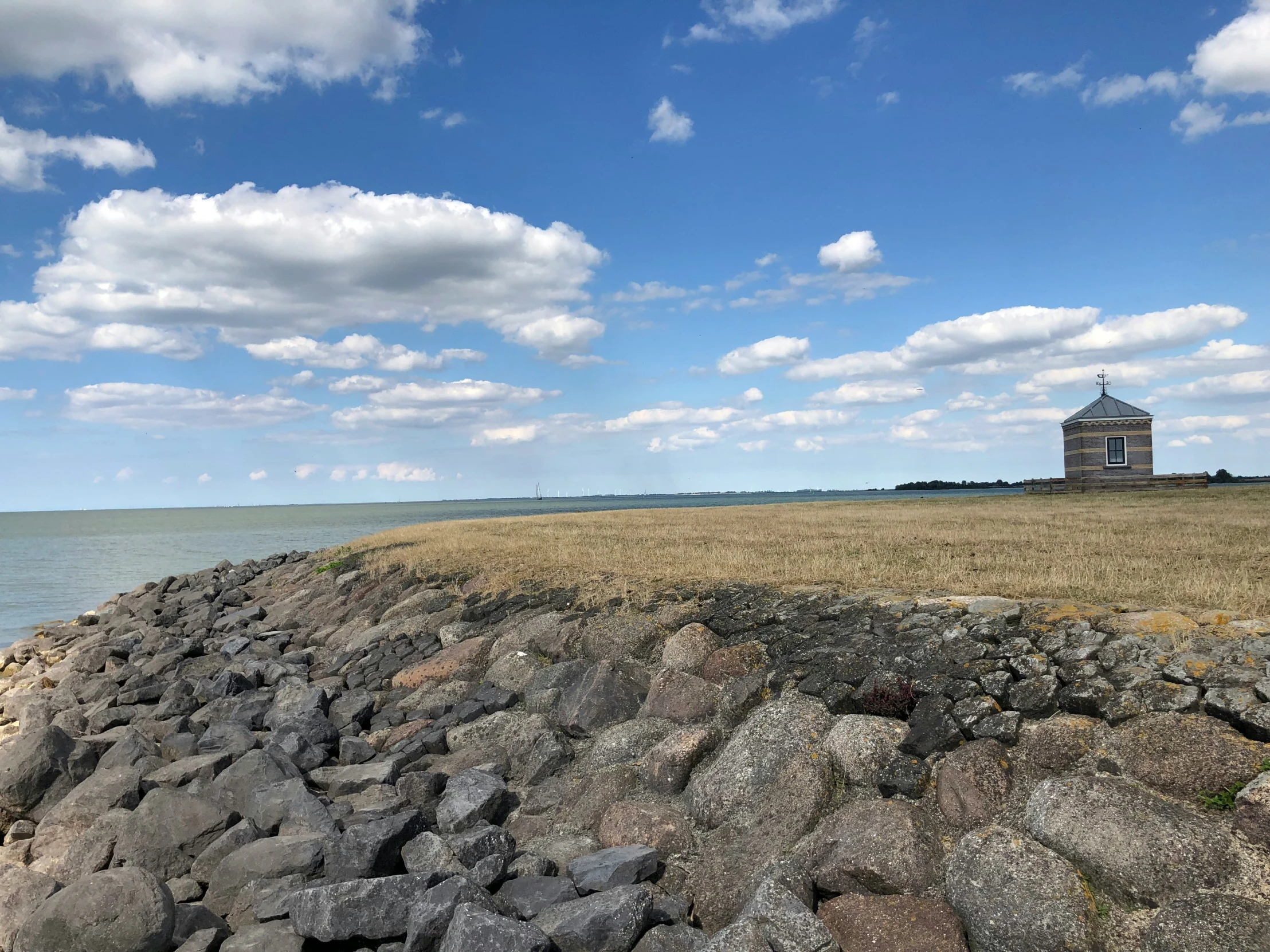 a stone wall near a body of water