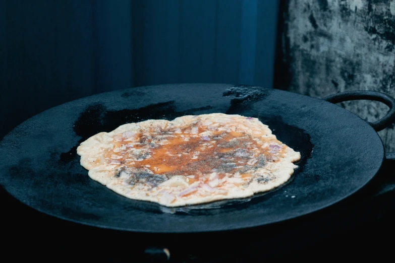 a pancake sitting on top of a black plate