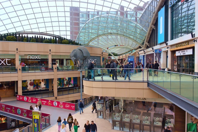 people walking through a mall shopping area