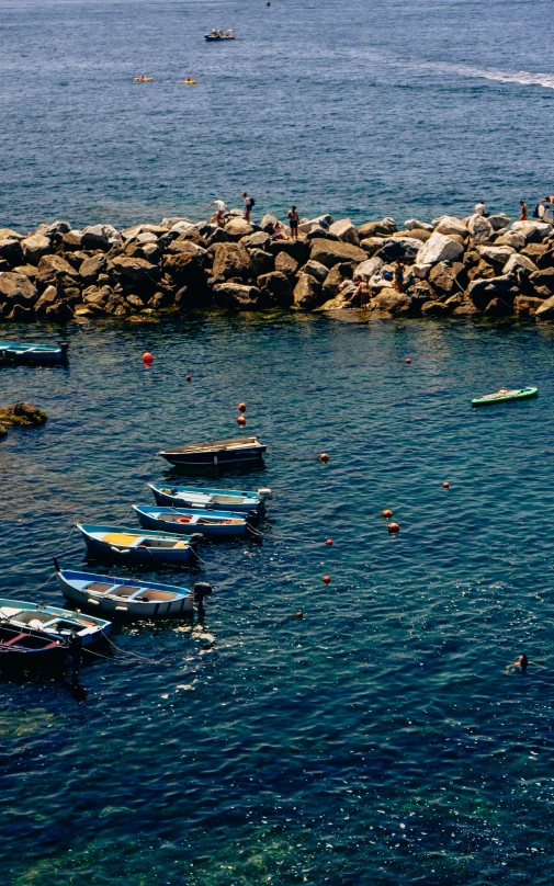 people enjoying boating on the beach while others watch