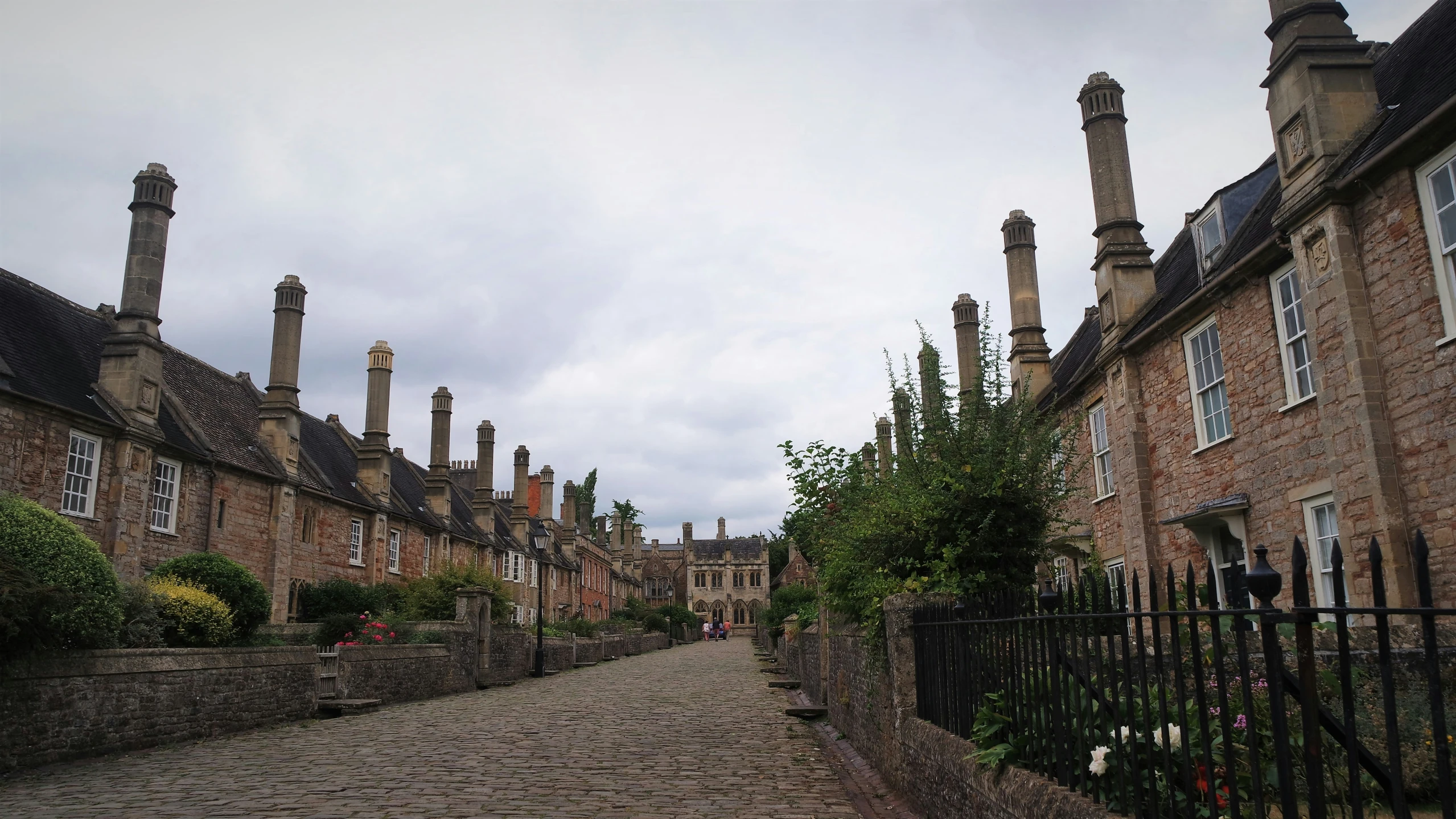 stone and brick buildings line a cobble stone path