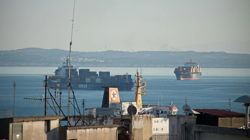 a large ship with cargo is near the harbor