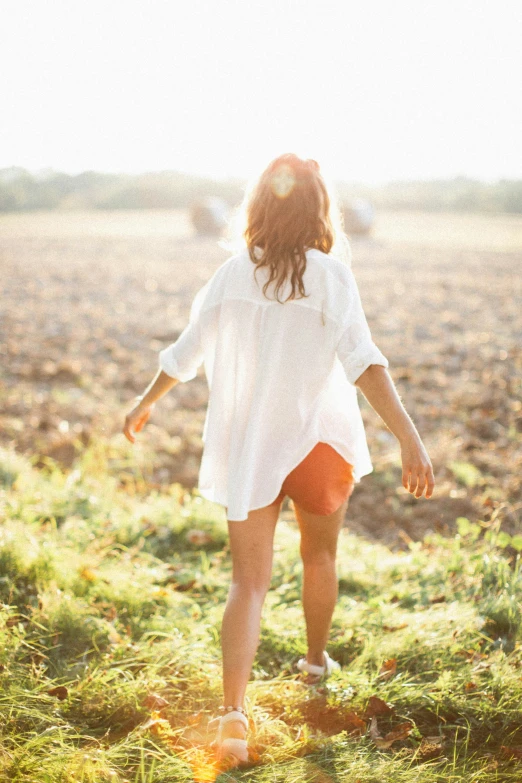 a woman standing on top of a grass field