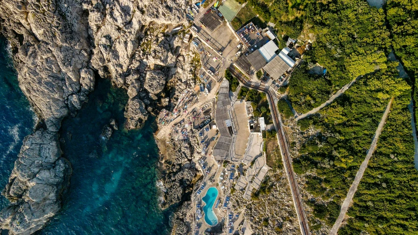 an aerial view of a body of water near a rocky cliff