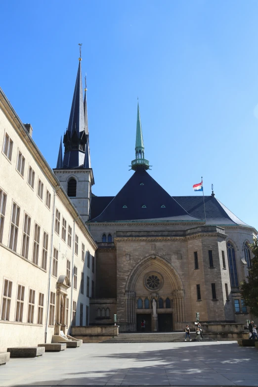 an ancient castle with a massive steeple and tall windows