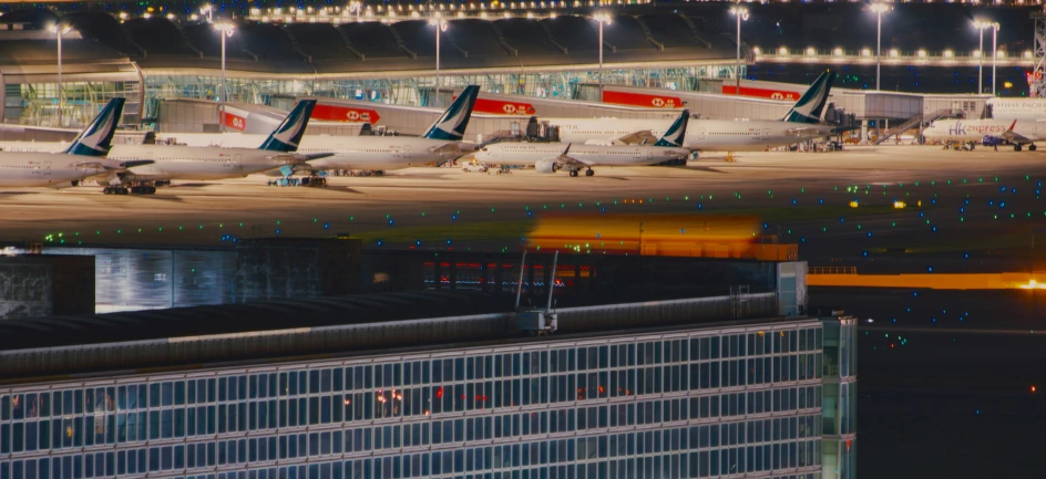 multiple airplanes are lined up on an airport runway