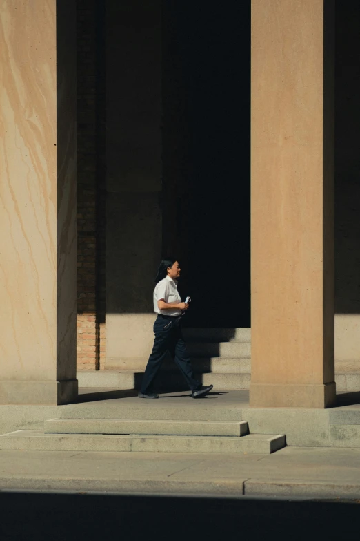 a man is walking down some concrete steps