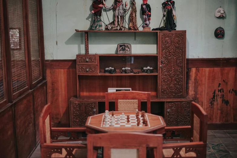 a chess board set with statues in a room