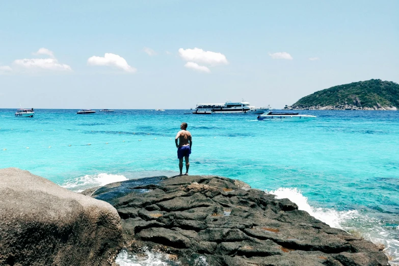 there is a man that is standing on a rock