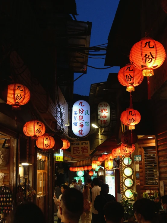 a street with asian lanterns in the evening