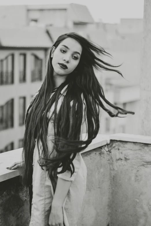 a woman with long hair posing for a picture