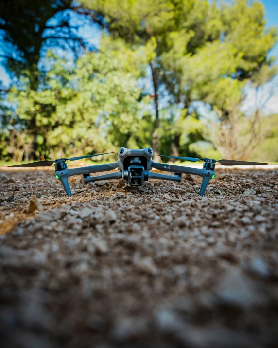 a flying toy sits in the dirt near trees