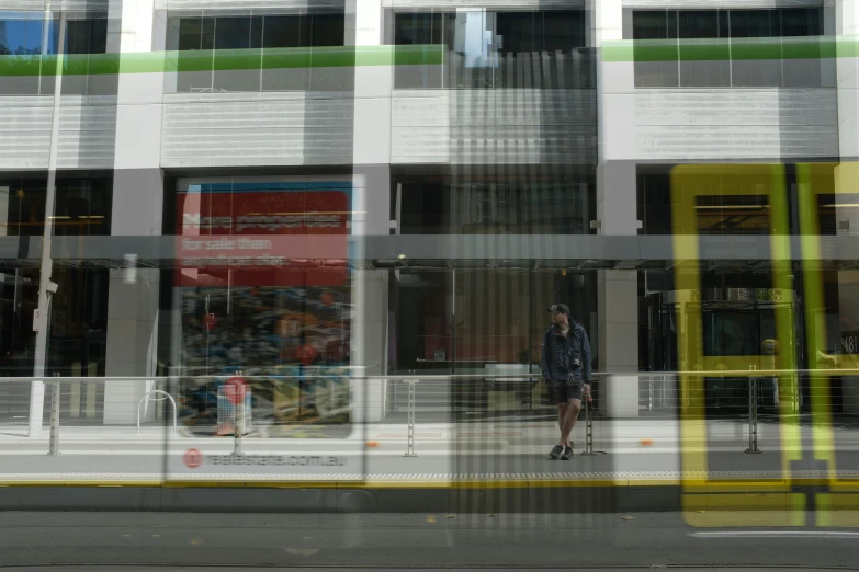 the reflection of a man on a building with buildings