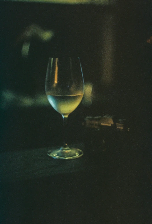 a glass sitting on a table next to a plate