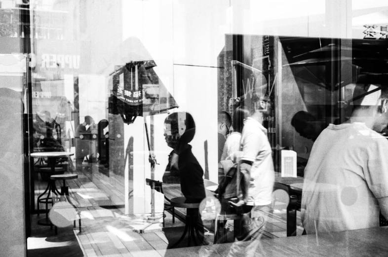 a po of people standing outside of a restaurant