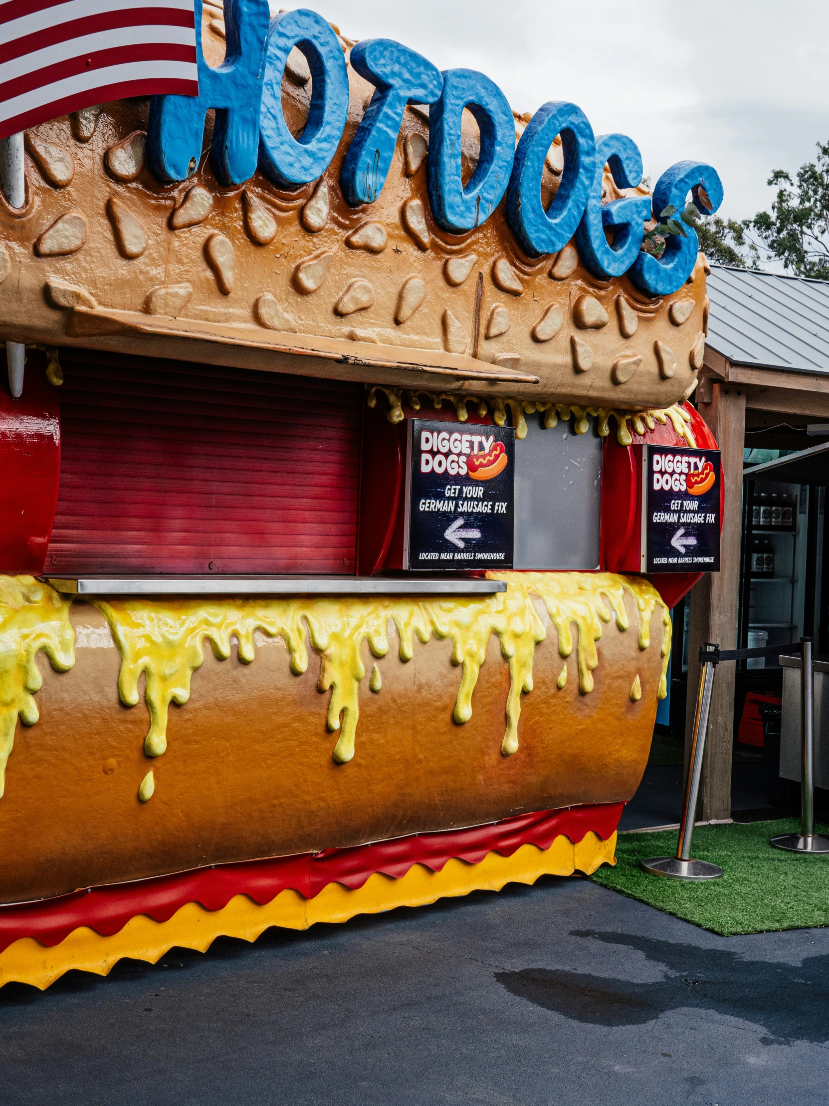 a huge  dog sitting in a long bun with icing on it