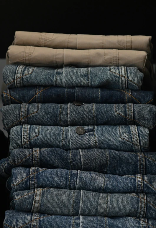 a stack of jean is sitting on a black table