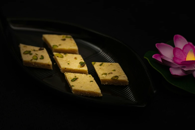 four slices of dessert sitting on a plate