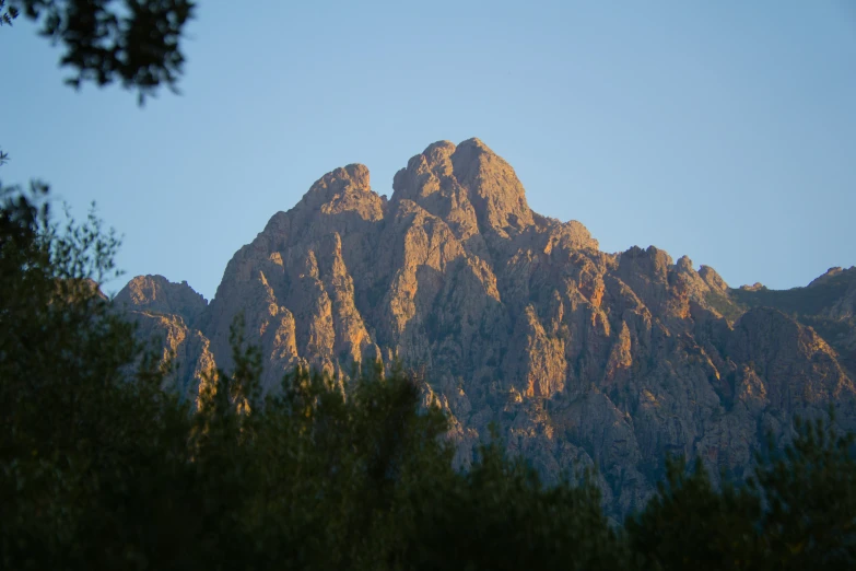 the mountains are silhouetted against the clear sky