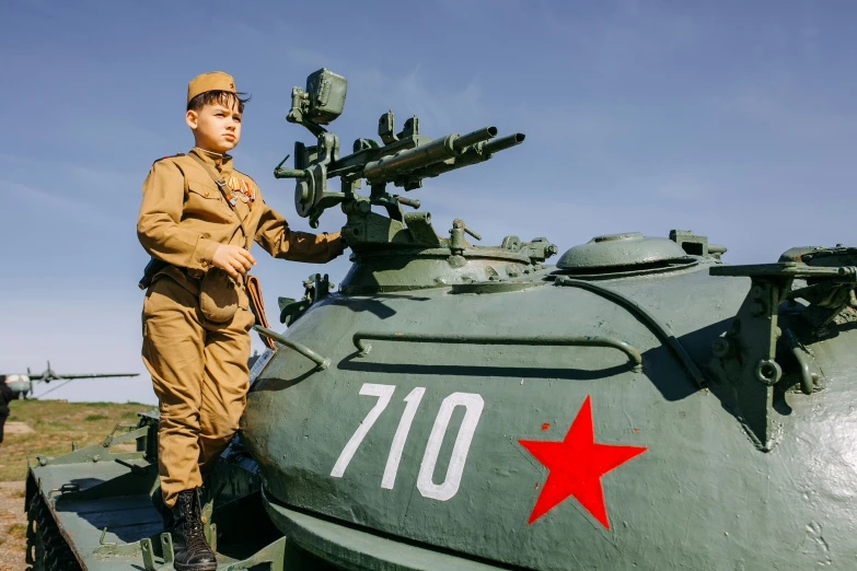 an image of man that is next to a military tank